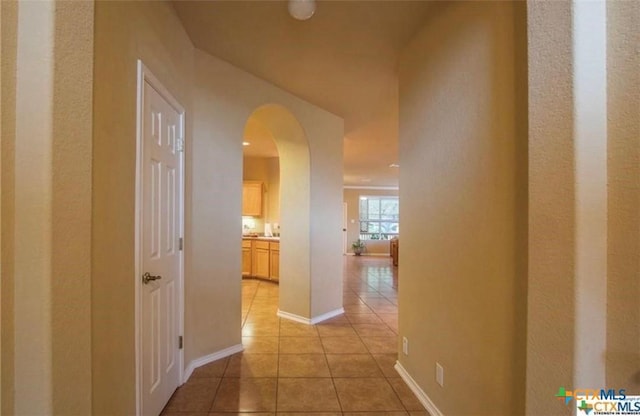 corridor with light tile patterned floors