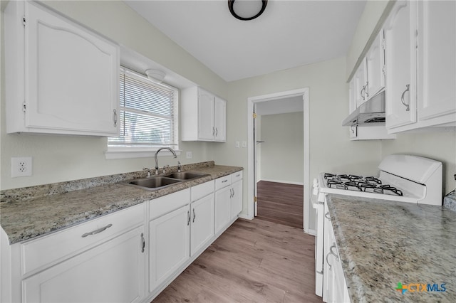 kitchen featuring light stone countertops, sink, white range with gas stovetop, light hardwood / wood-style floors, and white cabinets