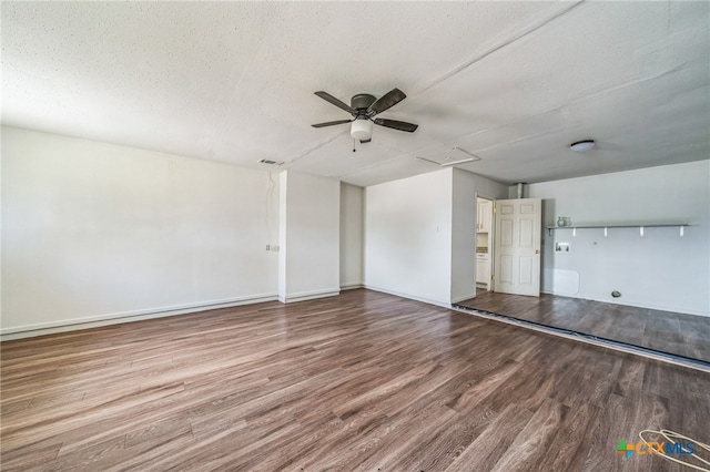 spare room with ceiling fan, wood-type flooring, and a textured ceiling