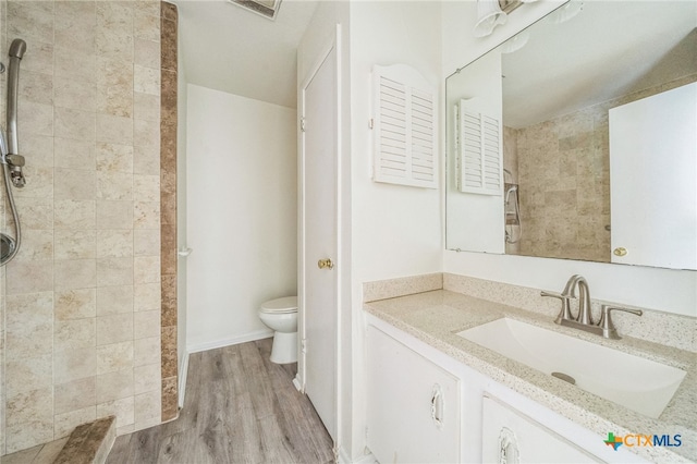 bathroom with vanity, hardwood / wood-style flooring, and toilet