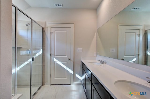 bathroom featuring vanity and an enclosed shower