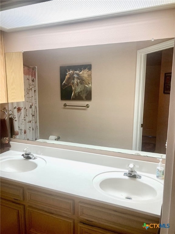 bathroom featuring walk in shower and vanity