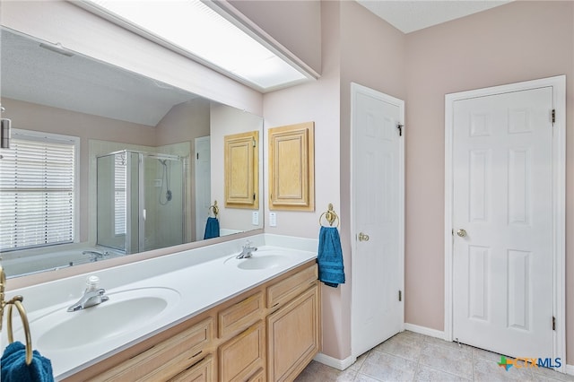 bathroom with vanity, a textured ceiling, plus walk in shower, tile patterned flooring, and lofted ceiling