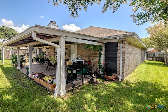 back of property featuring a patio and a lawn