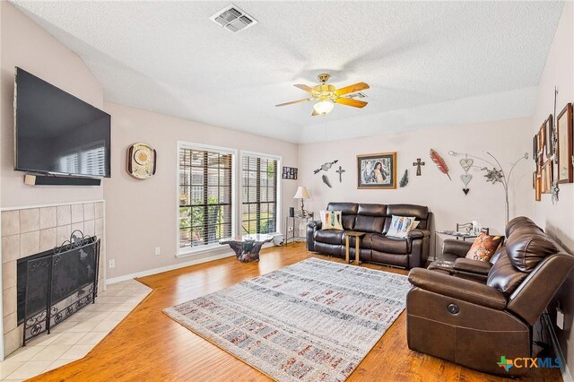 dining room with light colored carpet, vaulted ceiling, and a textured ceiling