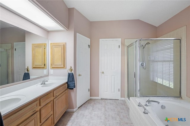 bathroom featuring independent shower and bath, vanity, vaulted ceiling, and tile patterned floors