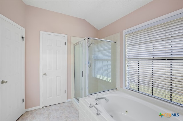 bathroom featuring tile patterned floors, separate shower and tub, vaulted ceiling, and a textured ceiling