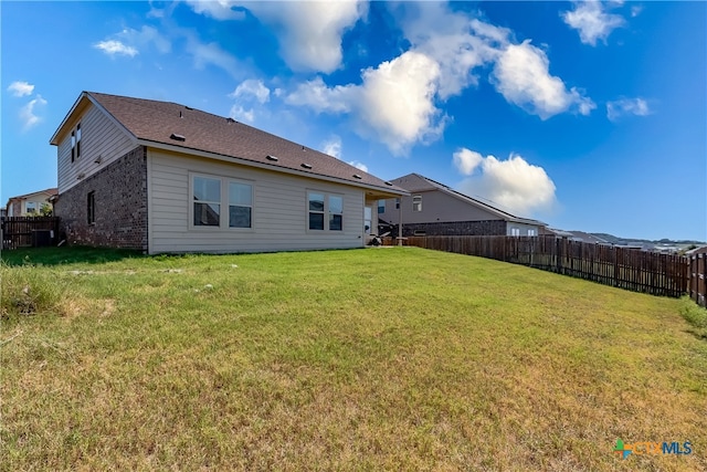 back of house featuring a yard