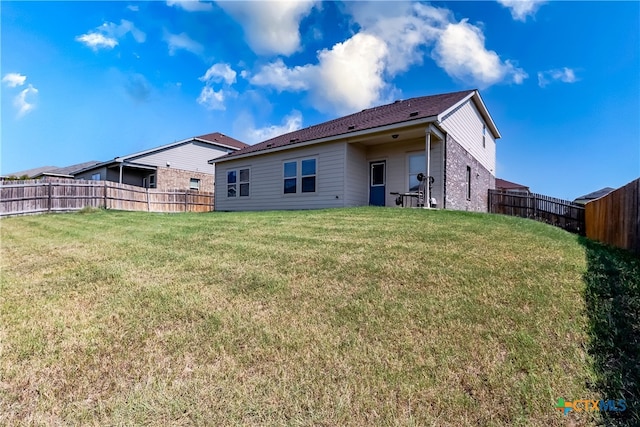 rear view of house with a lawn