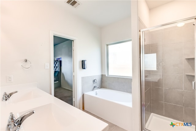 bathroom with double sink and independent shower and bath