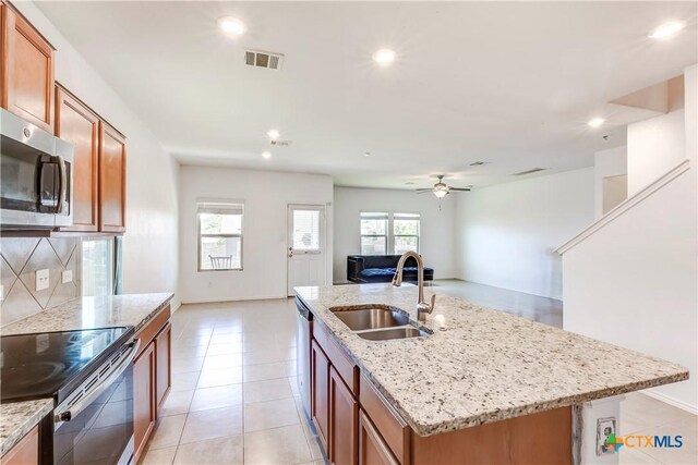 3802 Endicott Dr, Killeen, TX 76549 - kitchen featuring stainless steel appliances, open floor plan, recessed lighting, brown cabinetry, and decorative backsplash