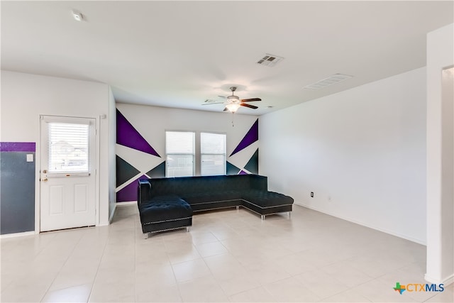 sitting room with plenty of natural light and ceiling fan