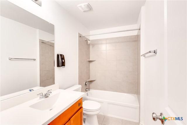 full bathroom with tile patterned flooring, vanity, tiled shower / bath combo, and toilet