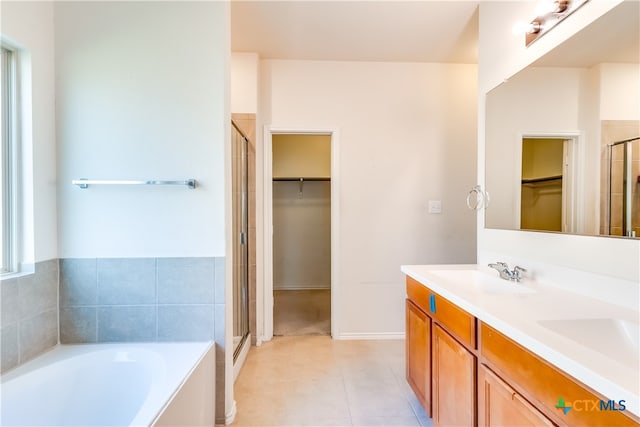 bathroom featuring vanity, tile patterned floors, and plus walk in shower