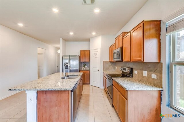 3802 Endicott Dr, Killeen, TX 76549 - kitchen with stainless steel appliances, light tile patterned floors, backsplash, light stone countertops, and recessed lighting