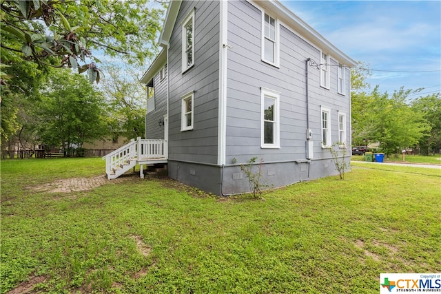 view of side of home with a lawn