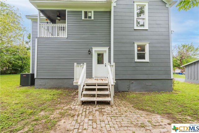 back of property with central AC unit and ceiling fan