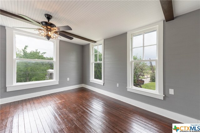 spare room with dark hardwood / wood-style floors and plenty of natural light