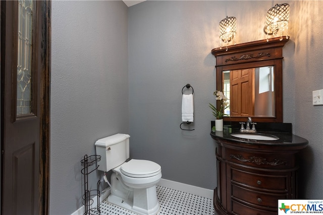 bathroom featuring vanity and toilet