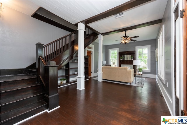 living room featuring ornate columns, dark hardwood / wood-style flooring, ceiling fan, and beam ceiling