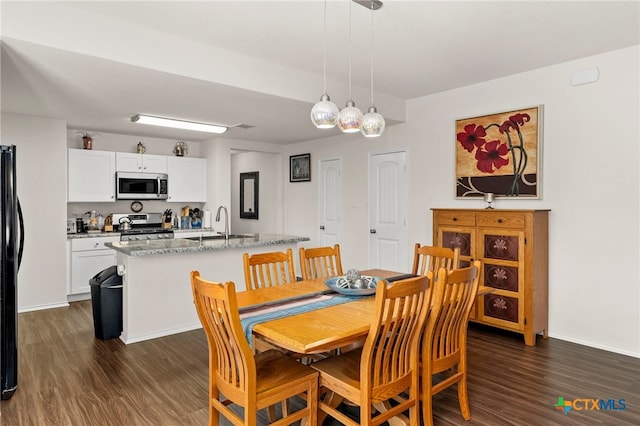 dining room with dark hardwood / wood-style floors