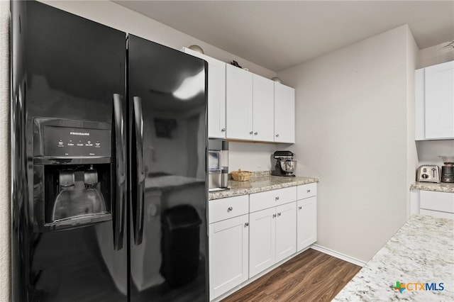 kitchen with dark wood-type flooring, white cabinetry, and black fridge with ice dispenser