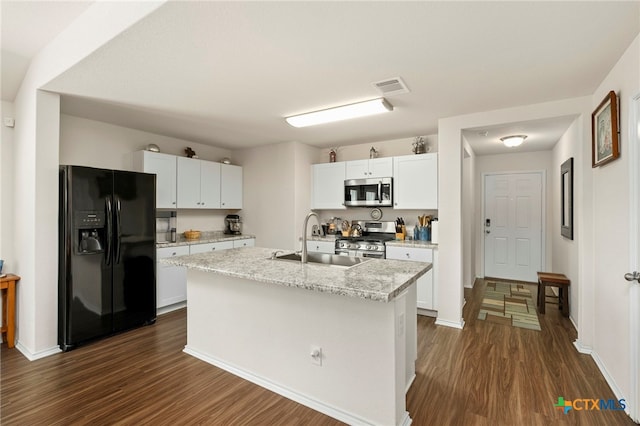 kitchen featuring a center island with sink, appliances with stainless steel finishes, sink, white cabinets, and dark wood-type flooring