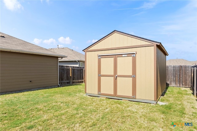 view of outbuilding featuring a yard