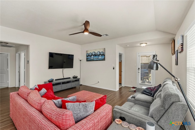 living room featuring dark hardwood / wood-style flooring, lofted ceiling, and ceiling fan