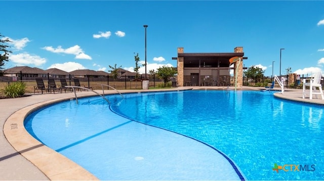 view of swimming pool with a patio