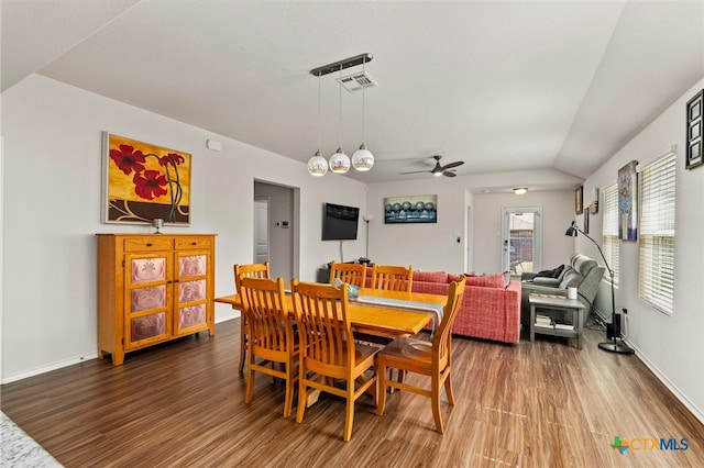 dining room featuring lofted ceiling, hardwood / wood-style flooring, and ceiling fan