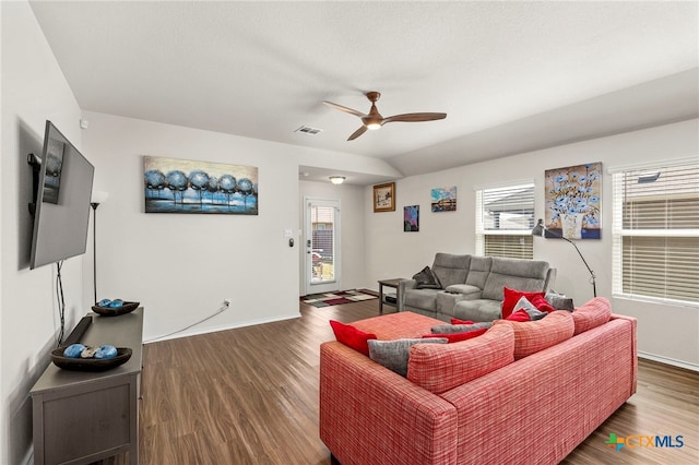 living room featuring ceiling fan and dark hardwood / wood-style floors