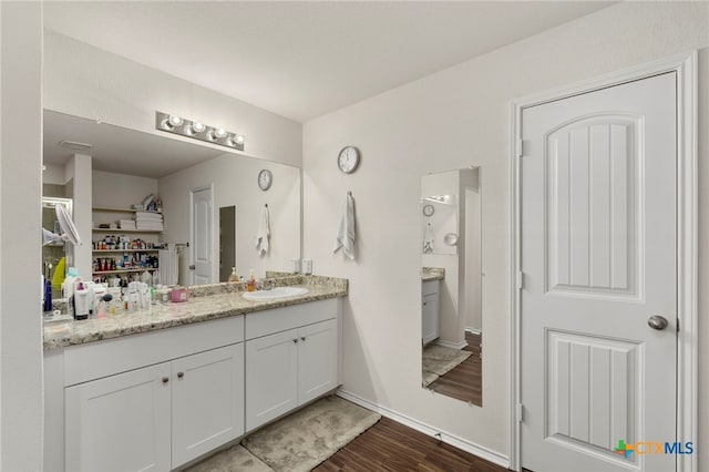 bathroom featuring vanity and hardwood / wood-style floors