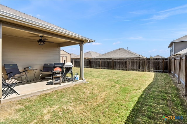 view of yard featuring ceiling fan and a patio