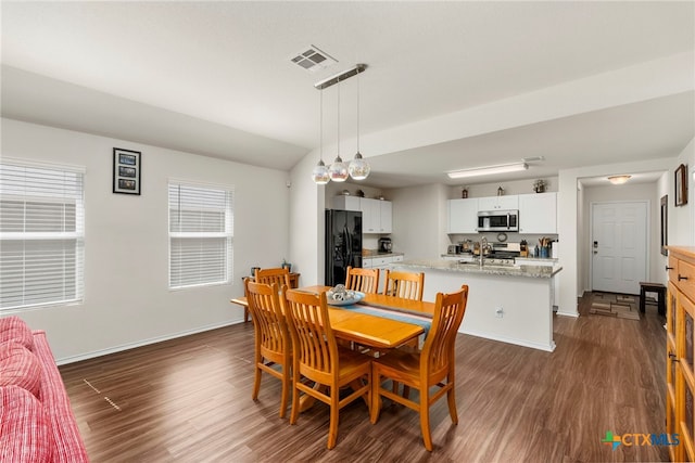 dining room with dark wood-type flooring and sink