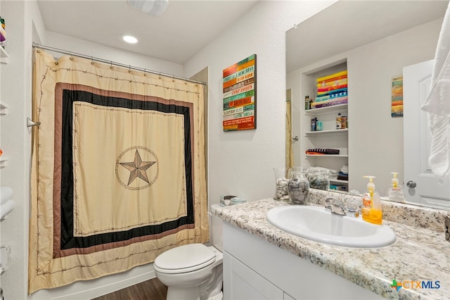 full bathroom featuring shower / tub combo with curtain, vanity, toilet, and hardwood / wood-style flooring