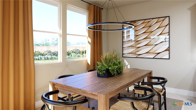 tiled dining room featuring plenty of natural light