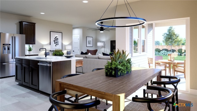 dining room with ceiling fan and sink