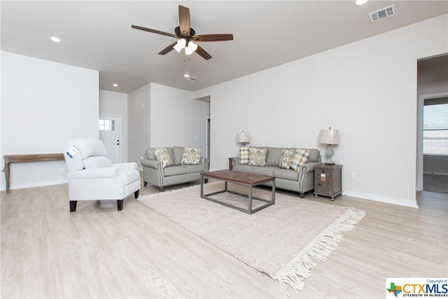 living room with light hardwood / wood-style floors and ceiling fan