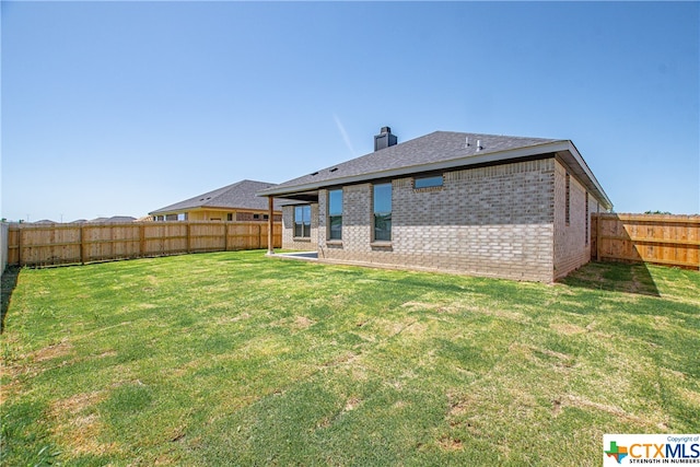 back of house featuring a lawn