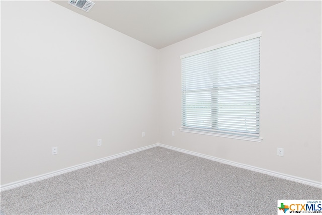 spare room featuring carpet