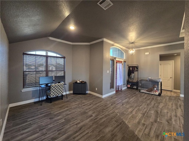 interior space featuring an inviting chandelier, dark wood-type flooring, lofted ceiling, a textured ceiling, and crown molding