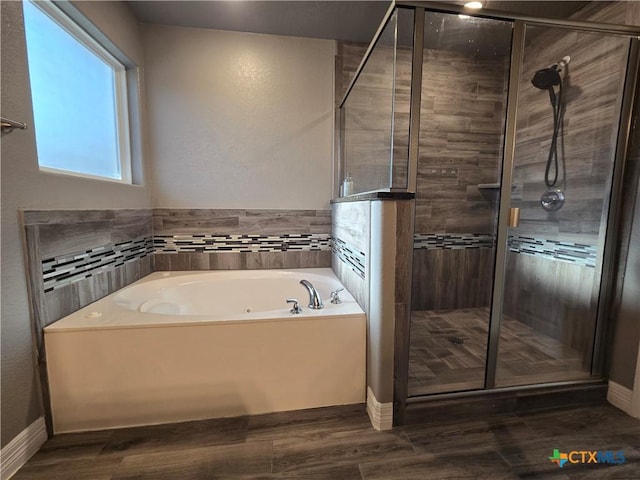 bathroom featuring separate shower and tub and hardwood / wood-style floors