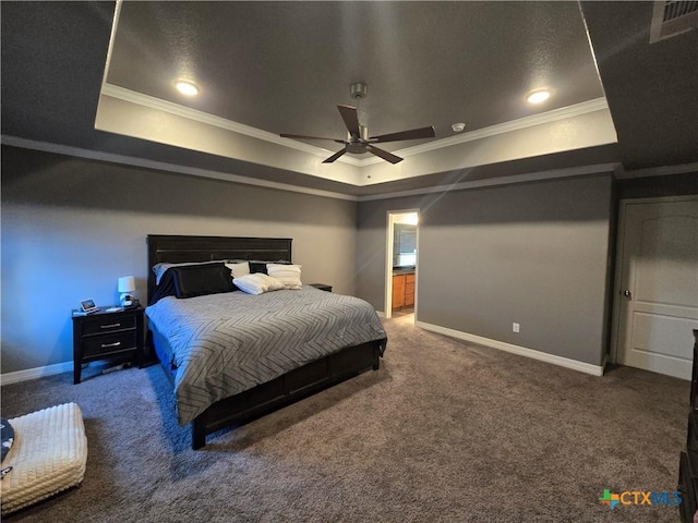 carpeted bedroom featuring ceiling fan, a tray ceiling, and ornamental molding