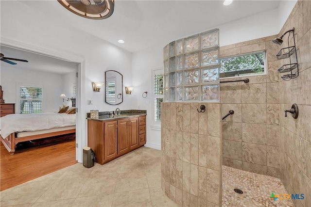 ensuite bathroom with walk in shower, ensuite bath, and a wealth of natural light