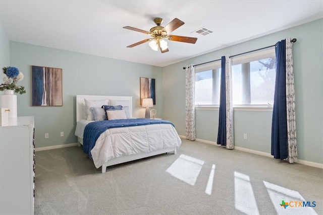 bedroom featuring ceiling fan and light carpet