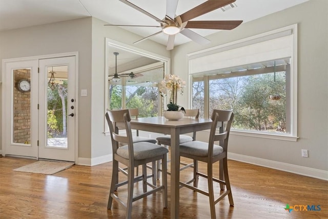 dining space featuring ceiling fan and hardwood / wood-style flooring