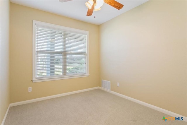 spare room featuring carpet floors and ceiling fan