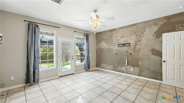 unfurnished room with an accent wall and a ceiling fan