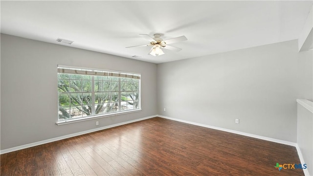 spare room with ceiling fan and dark wood finished floors
